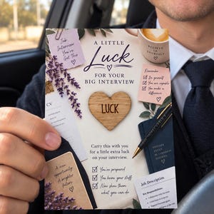 May include: A rectangular card titled A LITTLE LUCK FOR YOUR BIG INTERVIEW featuring a wooden heart with the word LUCK, lavender sprigs, a pen, and notes with text including Job Interview You've Got This, Believe In Yourself, and Job Description.
