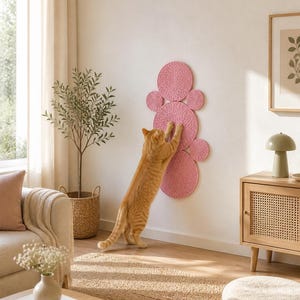 K&ouml;nnte beinhalten: Ein wandmontierter Kratzbaum f&uuml;r Katzen, bestehend aus sechs kreisf&ouml;rmigen Pads aus rosafarbenem, gewickeltem Seil. Die Pads sind in einem vertikalen, pfotenartigen Muster angeordnet und bieten eine strukturierte Oberfl&auml;che zum Kratzen.