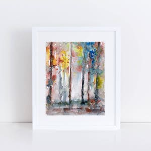 May include: Watercolor painting of a forest scene in a white frame. The artwork features vertical strokes of color, including yellow, red, blue, and gray, creating an abstract representation of trees and foliage. The painting is displayed on a white surface.