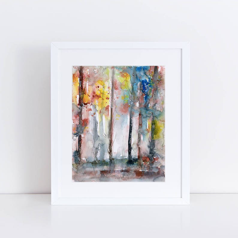 May include: Watercolor painting of a forest scene in a white frame. The artwork features vertical strokes of color, including yellow, red, blue, and gray, creating an abstract representation of trees and foliage. The painting is displayed on a white surface.