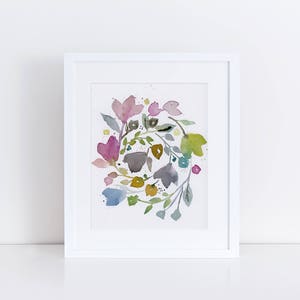 May include: A watercolor painting of a floral wreath with pink, blue, green, and yellow flowers. The flowers are arranged in a circular pattern and are surrounded by green leaves.