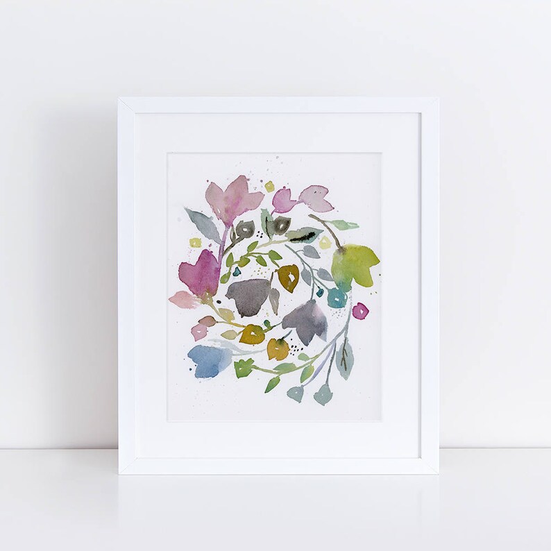 May include: A watercolor painting of a floral wreath with pink, blue, green, and yellow flowers. The flowers are arranged in a circular pattern and are surrounded by green leaves.