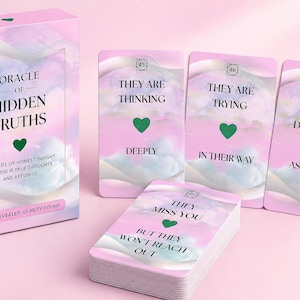 May include: A pink oracle card set with a matching box. The box and cards feature a dreamy cloud design and the words "Oracle of Hidden Truths." Individual cards display phrases like "They are thinking deeply" and "They miss you."