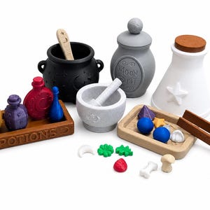 May include: A set of miniature potion-making accessories including a black cauldron with a stirring stick, a grey jar labeled Moon Dust, a white flask, a mortar and pestle, two wooden trays, one labeled Potions, and various small colorful charms.