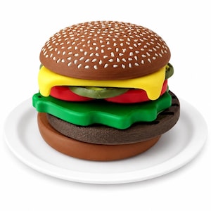 May include: A multi-layered burger figurine featuring a brown sesame seed bun, a yellow cheese slice, red tomato slices, green jalapeño rings, a green lettuce leaf, and a dark brown patty, all stacked on a plain white circular plate.