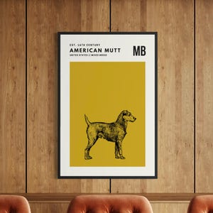 May include: A framed wall art print featuring a black ink illustration of a dog centered on a mustard yellow background. The text reads: EST. 16TH CENTURY, AMERICAN MUTT, UNITED STATES // MIXED BREED, and MB. The print is enclosed in a thin black frame.
