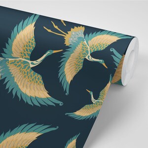 May include: A dark blue wallpaper with a repeating pattern of teal and gold cranes in flight. The cranes have detailed feathers and are set against a dark blue background.