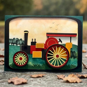 May include: A framed paper art piece showing a vintage tractor. The tractor is red, yellow, and black, with red and yellow wheels. The background features a green field, trees, and a yellow sky.
