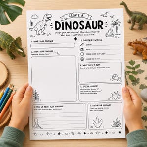 May include: A white paper activity sheet titled CREATE A DINOSAUR with black line art illustrations of dinosaurs, plants, and a volcano. The form includes sections to name, draw, and describe a dinosaur, including a fact file and special abilities.