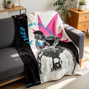 May include: A soft throw blanket featuring a black and white photograph of a person resting on a disco ball. The design includes a large pink starburst, blue text reading "WE BELONG TOGETHER," and black side panels with "TIME" and "MARCH" printed in white.
