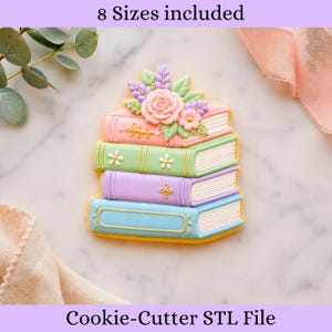 Puede incluir: Una pila de cuatro galletas coloridas con forma de libro, decoradas con detalles florales. La galleta superior es rosa, la segunda verde, la tercera morada y la inferior azul. El texto "8 Sizes included" y "Cookie-Cutter STL File" son visibles.
