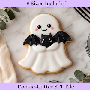以下が含まれることがあります： コウモリを抱えたゴーストのクッキー型STLファイル。ゴーストは白で黒い目とピンクの頬、コウモリは黒で白い目とピンクの頬をしています。8 Sizes IncludedおよびCookie-Cutter STL Fileというテキストが表示されています。