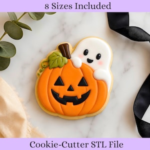 May include: A cookie cutter STL file featuring a jack-o'-lantern pumpkin with a smiling ghost peeking out from behind it. The design includes a green leaf and a brown stem on the orange pumpkin. The text 8 Sizes Included and Cookie-Cutter STL File is visible.