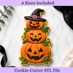 May include: A cookie cutter STL file featuring a stack of three orange jack-o'-lantern pumpkins with black carved faces. The top pumpkin wears a black witch hat with a purple band. Green vines and leaves accent the pumpkins. Text reads 8 Sizes Included.