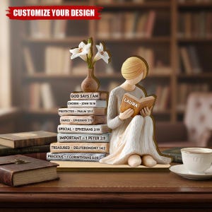 May include: A wooden figurine of a woman reading a book, with a stack of books featuring Bible verses. A vase with white flowers sits beside the figurine. The text "CUSTOMIZE YOUR DESIGN" is at the top.
