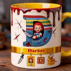 May include: A white ceramic mug with a yellow interior and handle, featuring a design of the character Chucky holding a knife inside a letter "D". The mug has a blood-like drip design at the top and the name "Darius" is printed on the mug.