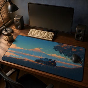May include: A rectangular desk mat featuring a printed illustration of a dark sports car parked in a grassy field at sunset, with a large mountain in the background under a blue and orange sky, positioned on a wooden desk surface.