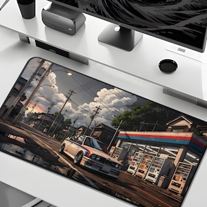May include: A rectangular desk mat featuring an anime-style illustration of a white sports car parked near a Japanese convenience store. The scene includes a street, buildings, and vending machines. The mat is designed for use with a computer.