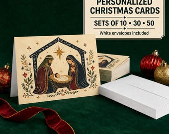 May include: A set of personalized Christmas cards featuring a nativity scene illustration with a star, Joseph, Mary, and baby Jesus. The cards are accompanied by white envelopes and a sign reading PERSONALIZED CHRISTMAS CARDS SETS OF 10 30 50.