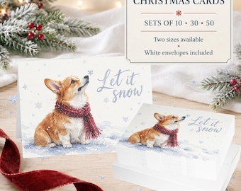 May include: A set of Christmas cards featuring a watercolor illustration of a Corgi wearing a red scarf in the snow with the text Let it snow. The cards are available in sets of 10, 30, or 50, with two sizes available and white envelopes included.