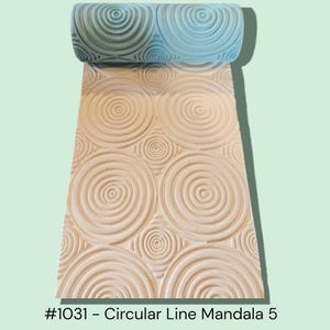 May include: A light blue cylindrical rolling pin with a raised texture featuring a repeating pattern of concentric circles and small circular motifs. The text #1031 – Circular Line Mandala 5 is printed in black at the bottom of the image.