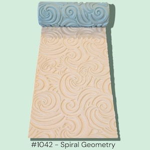 May include: A light blue and cream-colored spiral geometry roller. The roller is made of a hard material and features a repeating spiral pattern. The text "#1042 - Spiral Geometry" is at the bottom of the image.