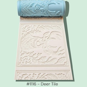 May include: A light blue patterned paint roller rests above a white, embossed tile. The tile features a deer design with floral and leaf accents. The text "#1116 - Deer Tile" is at the bottom.
