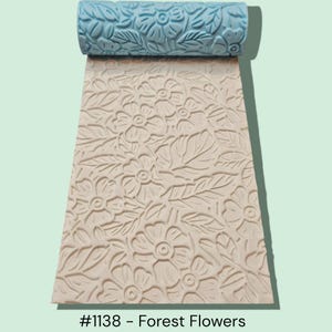 May include: A textured rolling pin with a floral pattern, unrolled onto a surface with the same design. The rolling pin is light blue, and the surface is a light beige color. The text "#1138 - Forest Flowers" is at the bottom.