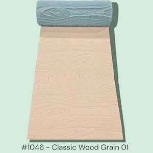 May include: A light blue textured roller sits atop a beige surface with a wood grain pattern. The pattern is visible on the unrolled portion, displaying detailed wood grain. The text "#1046 - Classic Wood Grain 01" is at the bottom.