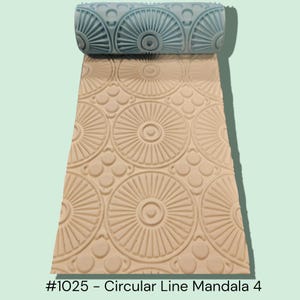 May include: A light blue and beige patterned texture roller with a circular mandala design. The roller is partially rolled out, revealing the embossed pattern. The text "#1025 - Circular Line Mandala 4" is visible.