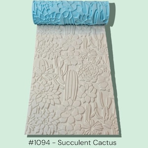May include: A light blue patterned rolling pin rests above a sheet embossed with a succulent and cactus design. The sheet is off-white and features detailed floral and cactus patterns. The text "#1094 - Succulent Cactus" is at the bottom.