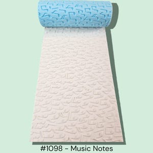 May include: A blue and white textured rolling pin with a musical notes pattern. The rolled portion is blue, and the unrolled portion is white. The text "#1098 - Music Notes" is at the bottom.