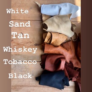 May include: Six leather swatches in various shades of brown, from white to black, labeled with their color names: White, Sand, Tan, Whiskey, Tobacco, Black.