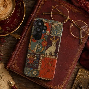 May include: A smartphone case featuring a multi-panel design with illustrations of a crowned cat, a red lion, a bull, a hand holding flowers, and a sun face. The case has a dark background with red, gold, and blue accents, and a triple camera cutout.