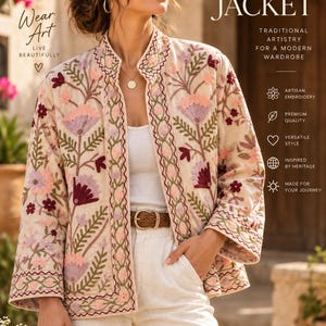 May include: A beige jacket featuring intricate floral embroidery in shades of pink, burgundy, and green. The jacket has a stand-up collar, long sleeves, and an open front. Text on the image includes "SUZANI JACKET", "Wear Art", and "LIVE BEAUTIFULLY".