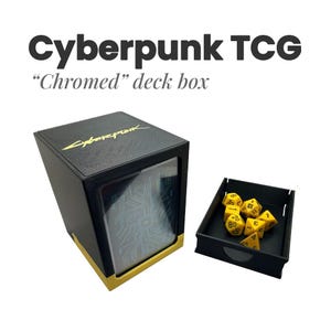 May include: A black deck box with a yellow Cyberpunk logo on top and a circuit board pattern on the front window. Next to it is a small black tray containing several yellow multi-sided dice with black numbers. Text reads Cyberpunk TCG.