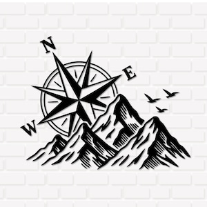 May include: Black and white wall art depicting a compass rose, mountains, and birds in flight. The compass rose is positioned above the mountain range, with cardinal points labelled. The birds are shown soaring.