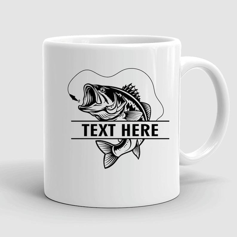 May include: White ceramic mug featuring a black and white illustration of a largemouth bass with an open mouth, a fishing hook, and the text "TEXT HERE" in a bold font. The mug has a curved handle.