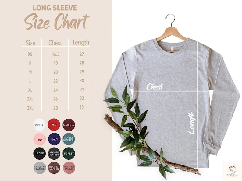 Puede incluir: Una camiseta de manga larga gris claro colgada de una percha de madera, con una tabla de tallas y muestras de color. La tabla de tallas muestra las medidas de pecho y largo en cm. Las opciones de color incluyen blanco, rojo, granate, rosa, azul marino y negro.