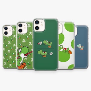 May include: A collection of five phone cases featuring Yoshi from the Super Mario franchise. The cases display various green and white designs, including Yoshi characters, eggs, and polka dots. The cases are made of clear plastic.