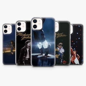 May include: Five clear phone cases showcasing images of Michael Jackson. The cases feature different performance shots of the artist, with a black background and the name "Michael Jackson" in gold script.