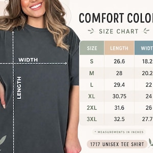 May include: A charcoal gray short-sleeve t-shirt paired with a Comfort Colors size chart. The chart displays length and width measurements in inches for sizes S through 3XL, specifically for the 1717 unisex tee shirt model, with clear labels.