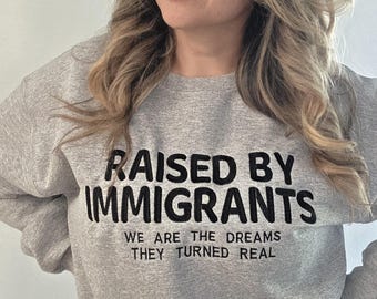 RAISED BY IMMIGRANTS embroidered crewneck