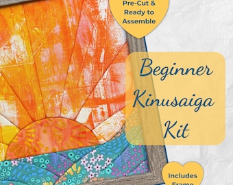 May include: A beginner Kinusaiga kit featuring a fabric art piece with a sunburst design in orange, yellow, and red tones above a teal landscape with floral patterns. The kit includes a wooden frame, with text stating Pre-Cut & Ready to Assemble.