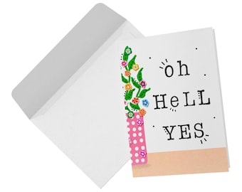 May include: A white greeting card and matching envelope. The card features a pink polka-dot vase with green stems and colorful floral accents on the left side. The text "oh HeLL YES" is printed in black on the right side above a peach-colored base.