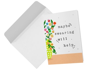 May include: A white greeting card and a matching white envelope. The card features a green vase with white polka dots containing colorful flowers and the black text maybe swearing will help, set against a peach-colored base and scattered dots.