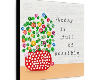May include: A square wall art piece featuring a red pot with white polka dots filled with colorful flowers in shades of pink, yellow, blue, and green. The background displays faint dictionary text and the words today is full of possible.