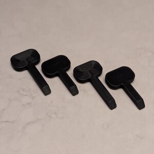 May include: A white ceramic mug with a black handle and the text "But First, Coffee" in a black, bold font. The mug is sitting on a wooden surface. The mug is approximately 4 inches tall.