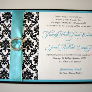 May include: A wedding invitation with a black and white damask pattern, a turquoise blue ribbon, and a rhinestone embellishment. The invitation text reads "Our love today we share it with you... Brandy Hanh Teresa Edwards and James Rolland Souza Jr. request your presence to share their love and commitment on Saturday, the 14th of September, 2013 at 2 o'clock in the afternoon Lanikuhenua Beach Ke Olina, Hawaii Oahu."