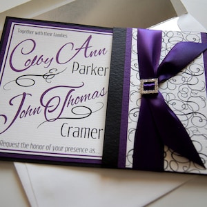 May include: A wedding invitation with a purple ribbon and a black and white background. The invitation reads "Together with their families Colby Ann & Parker John Thomas Cramer Request the honor of your presence as..."